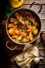 Oriental chicken with quince and cinnamon in pan — Stock Photo