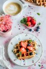 Waffles with strawberries and blueberries — Stock Photo