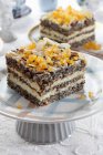 Poppy seed cake layer with orange and almond flakes — Stock Photo