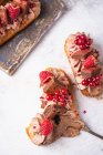 Eclairs with chocolate cream, brownie and berries — Stock Photo