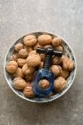 Bowl of walnuts with nut cracker — Stock Photo
