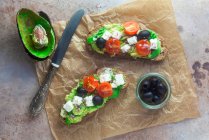 Avocado-Toast mit Feta-Käse, Tomaten und Oliven — Stockfoto