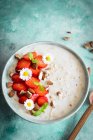 Oatmeal with strawberries close-up view — Stock Photo