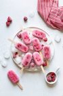 Raspberry ice cream on sticks — Stock Photo