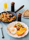 Roasted potatoes and sweet potatoes with egg — Stock Photo