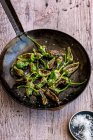 Grilled eggplant with green peas and garlic — Stock Photo