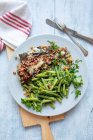 Bacon coated plaice with green beans — Stock Photo