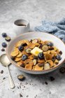 Pancake cereal with blueberries, chocolate, butter and maple syrup — Stock Photo