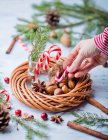 Candycanes and Christmas wreath with nuts — Stock Photo