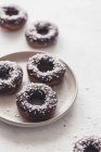Donuts with chocolate glaze and coconut shreds — Stock Photo