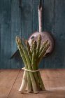 Bundle of asparagus in a country kitchen — Stock Photo