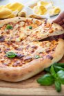 Cheese pizza with basil — Stock Photo