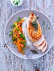 Chicken breast fillet with sage served with spring vegetables and dip — Stock Photo