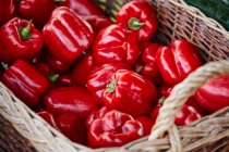 Red peppers in a basket on a market stall — Stock Photo
