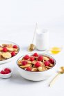 Mini pancake cereal with raspberries in a bowl — Stock Photo