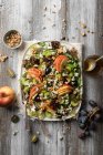 Apple salad with grapes, gorgonzola, celery sticks, walnuts and mustard dressing — Stock Photo