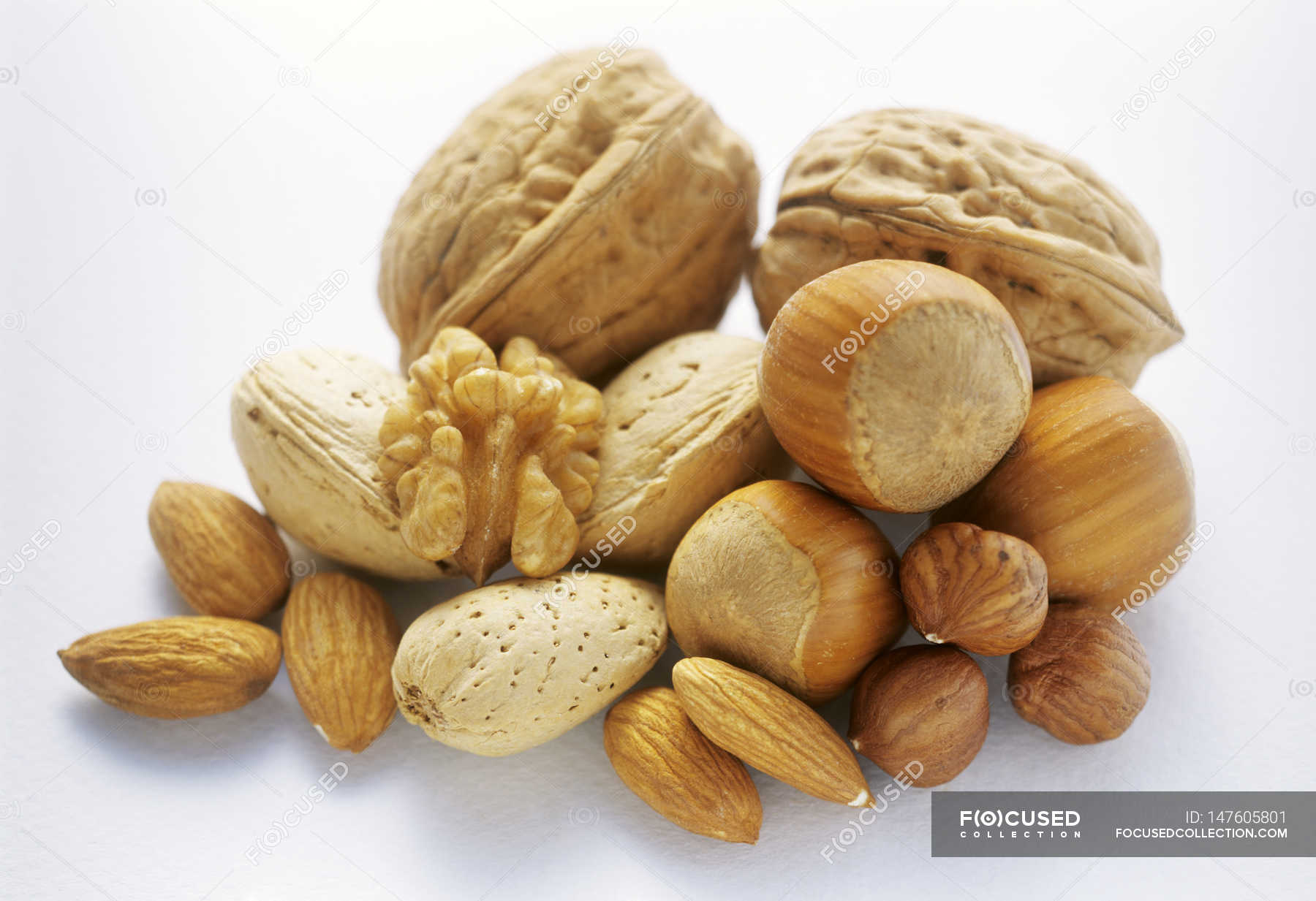 Raw mixed nuts in heap — clean eating, organic food Stock Photo