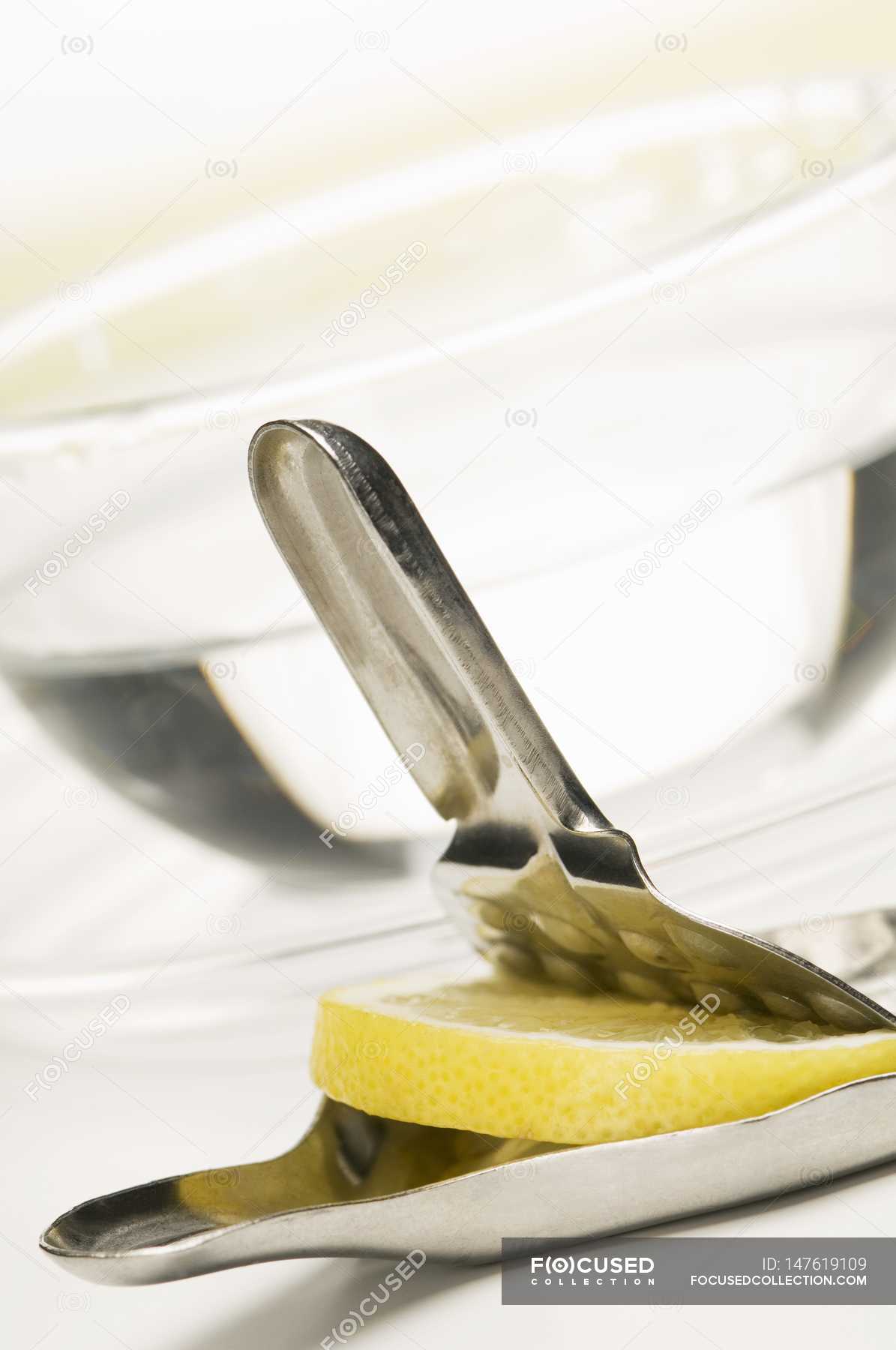 Lemon press with slice of lemon — nutrients, juice Stock Photo