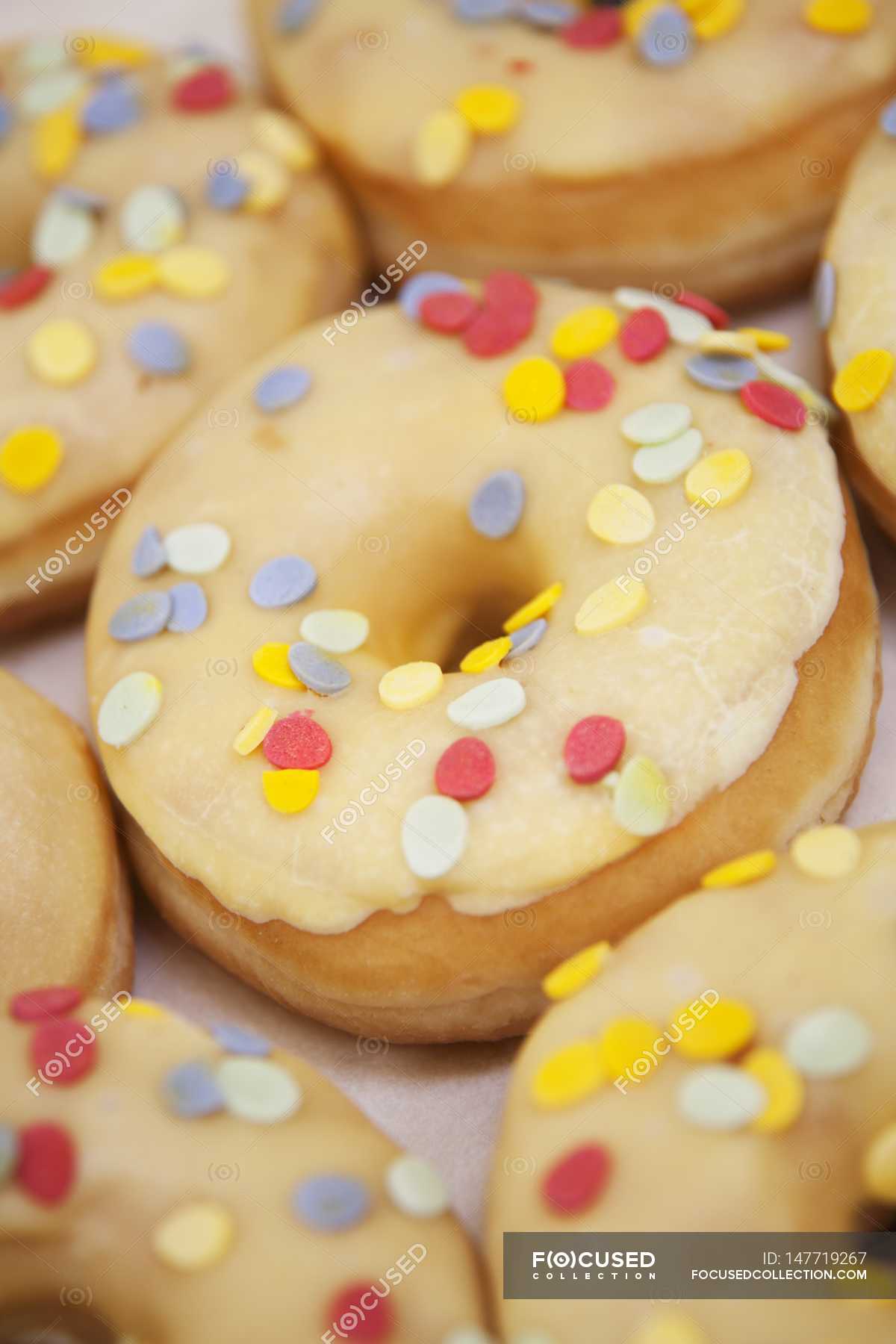 Iced donuts with confetti sprinkles — macro, peasant fritters Stock