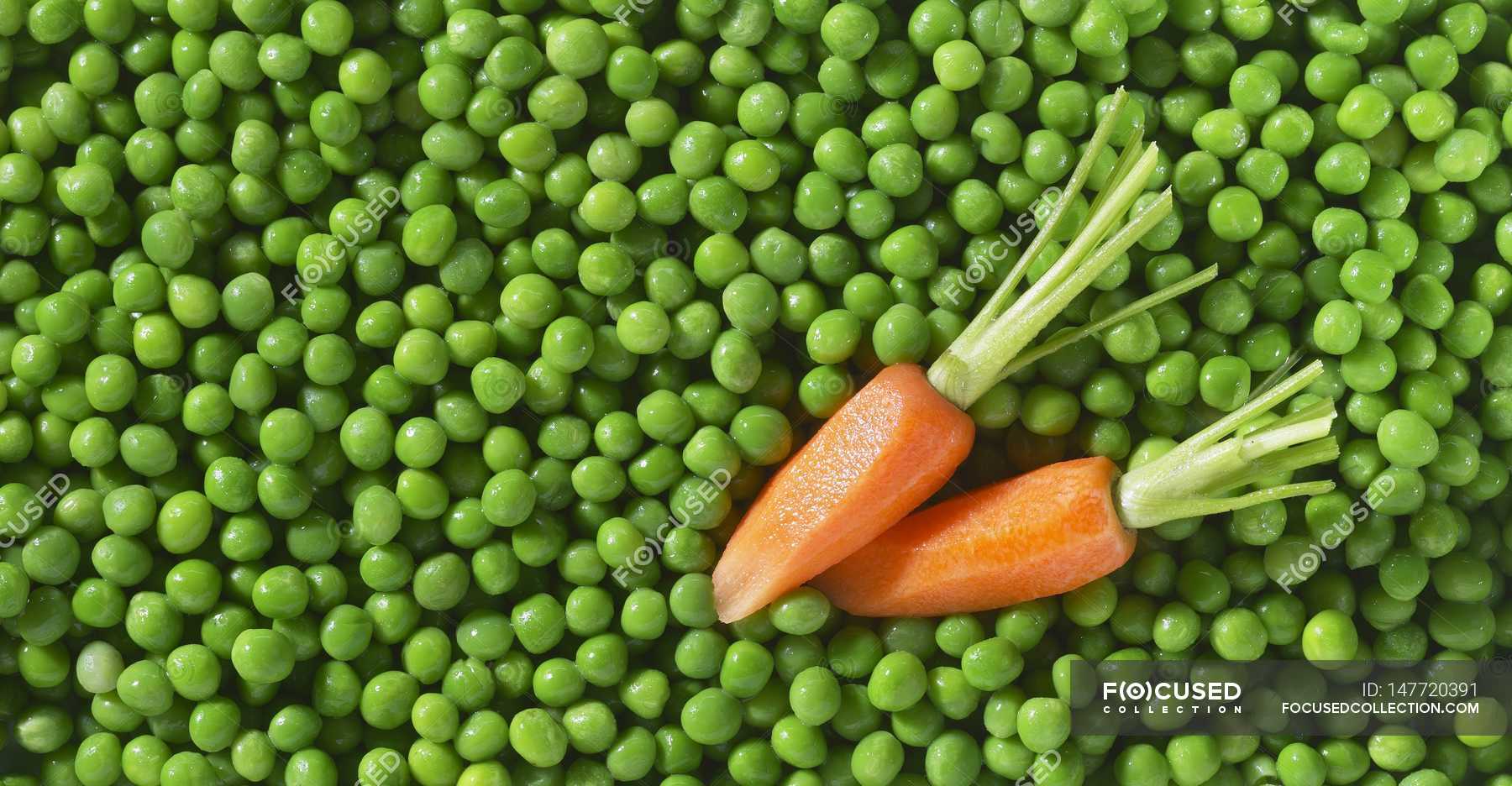 Frozen peas and carrots — background, yummy Stock Photo 147720391