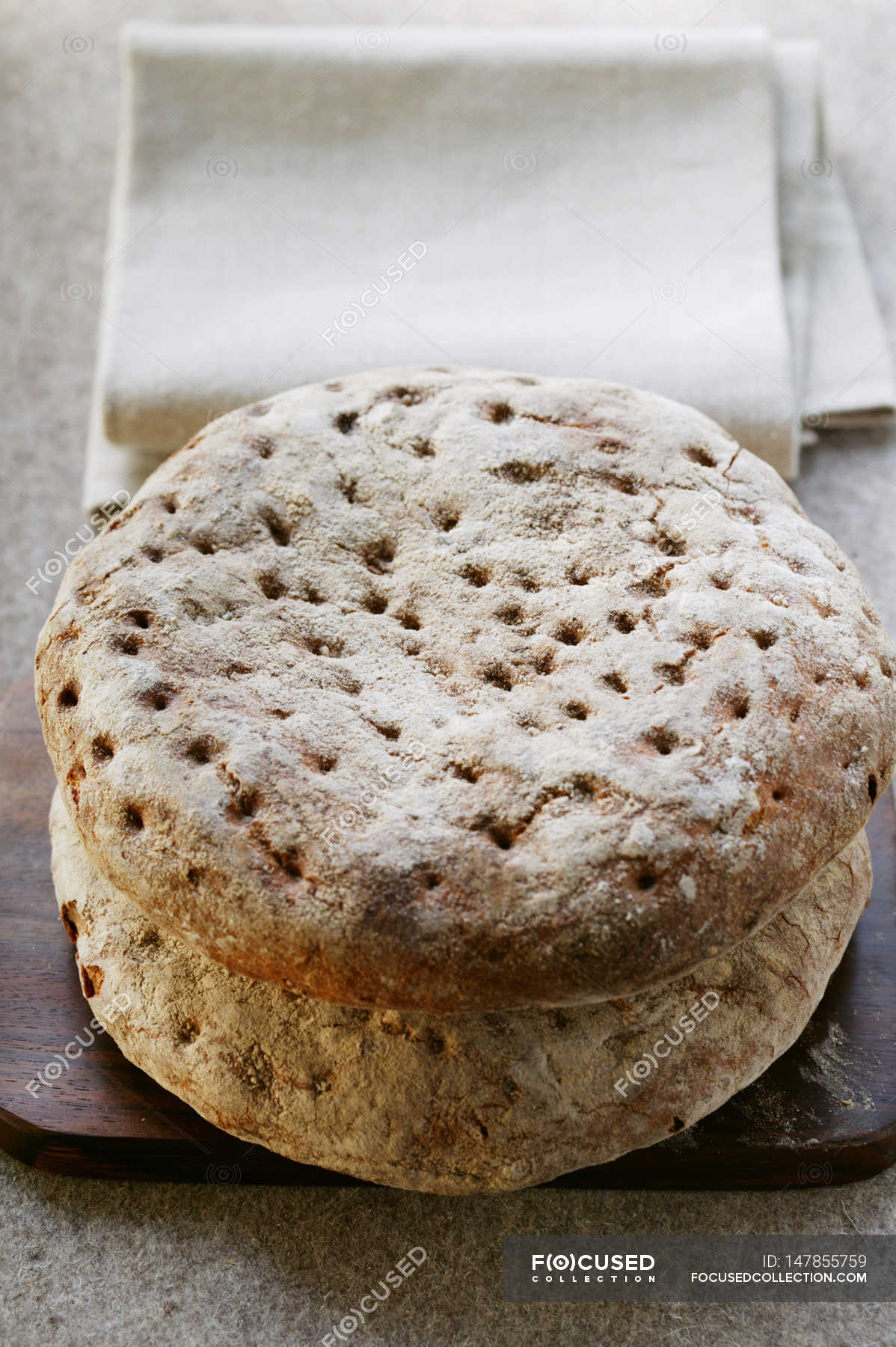 Rustic flatbreads on wooden board — baked, freshly baked Stock Photo
