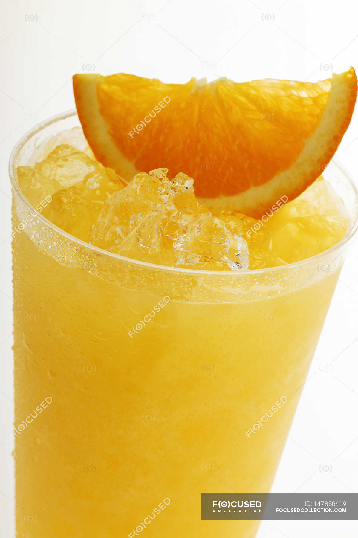Orange juice with crushed ice — orange piece, close up Stock Photo