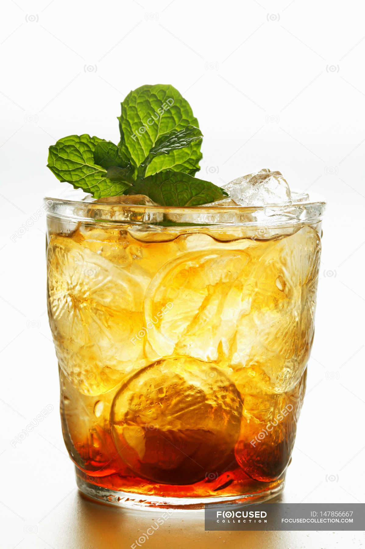 Iced tea with fresh mint in glass — Front View, white Stock Photo