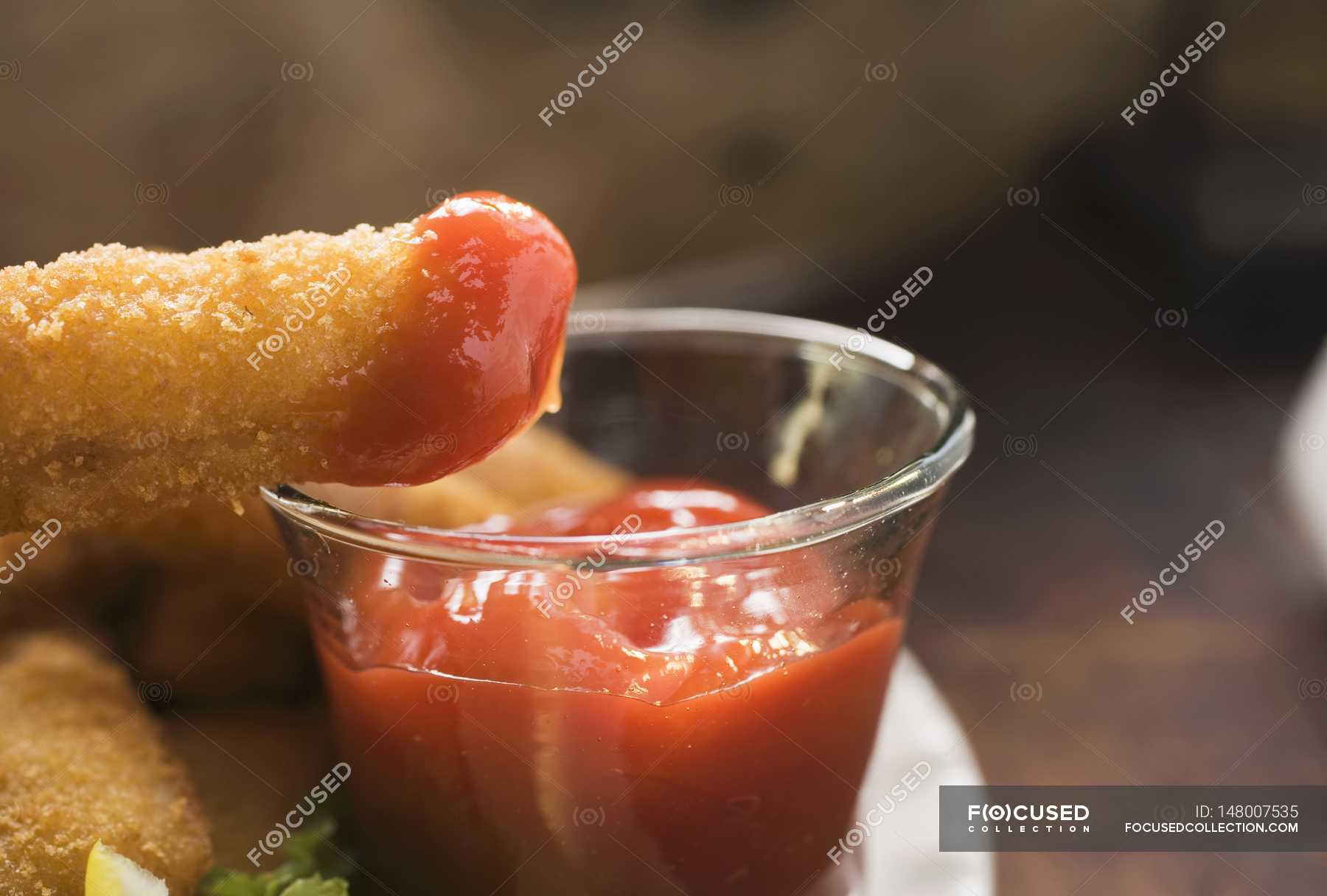 Fish finger with ketchup — nutrition, fast food Stock Photo 148007535