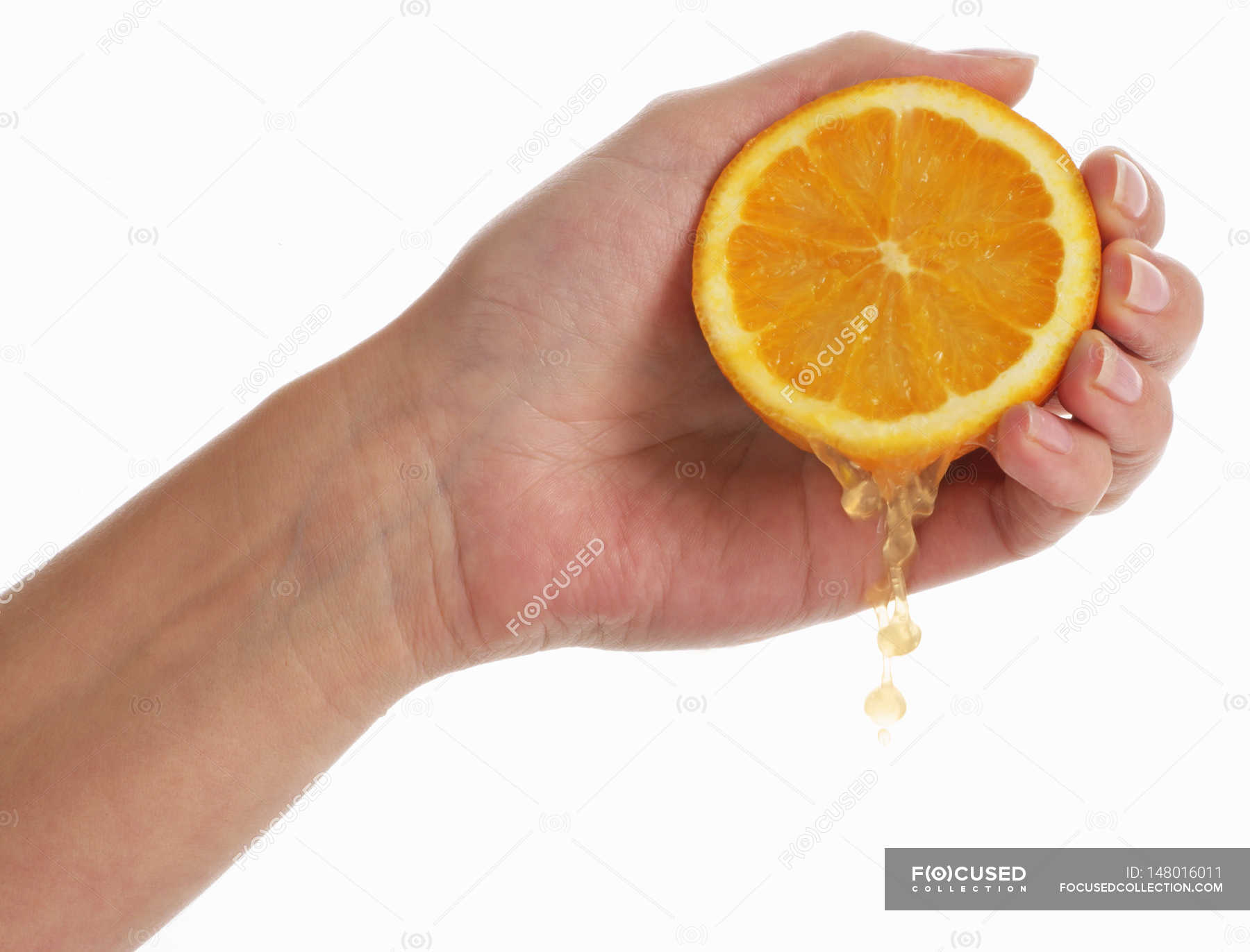 Hand squeezing orange — seasonal, diet Stock Photo 148016011