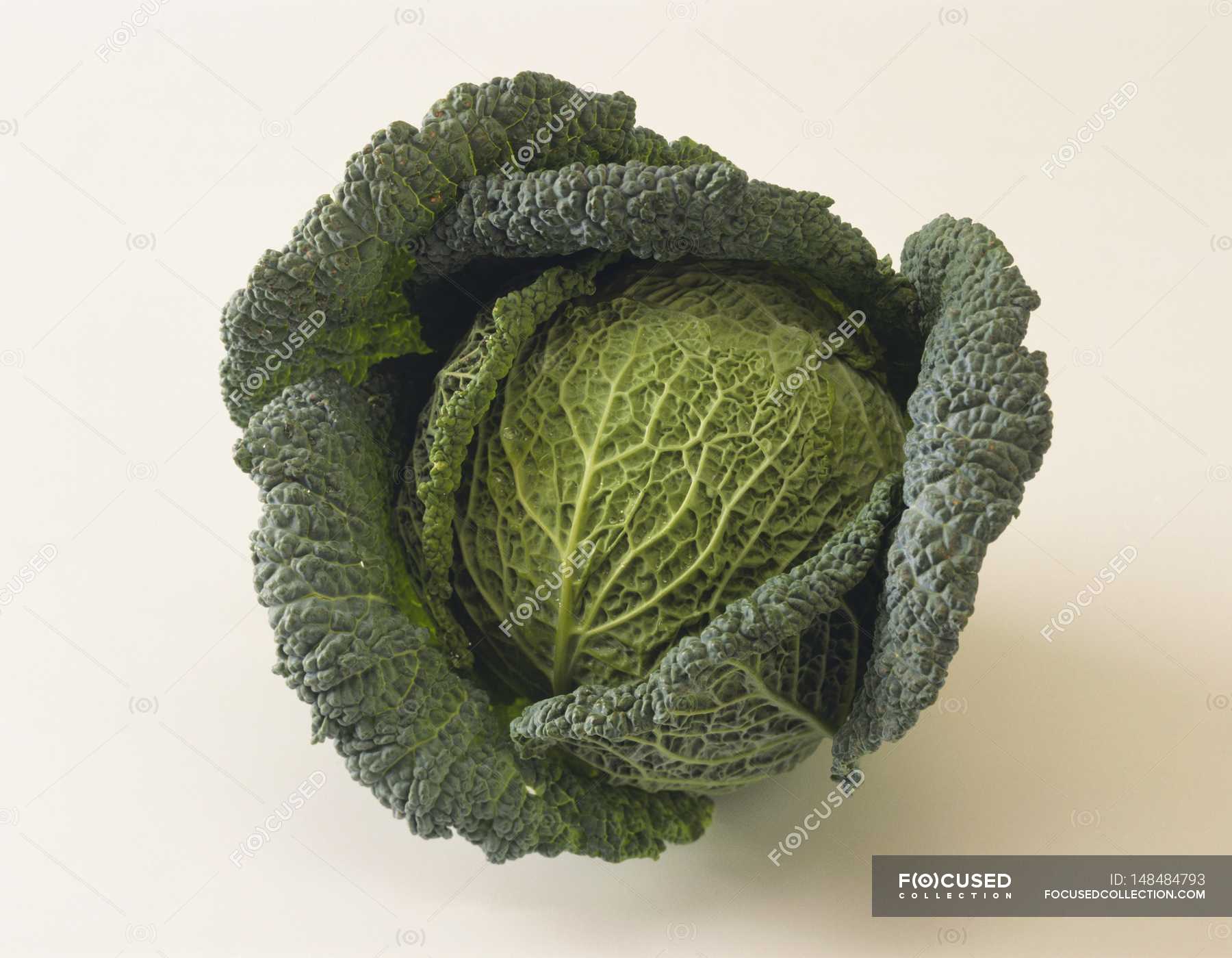 Green savoy cabbage — raw food, uncooked Stock Photo 148484793