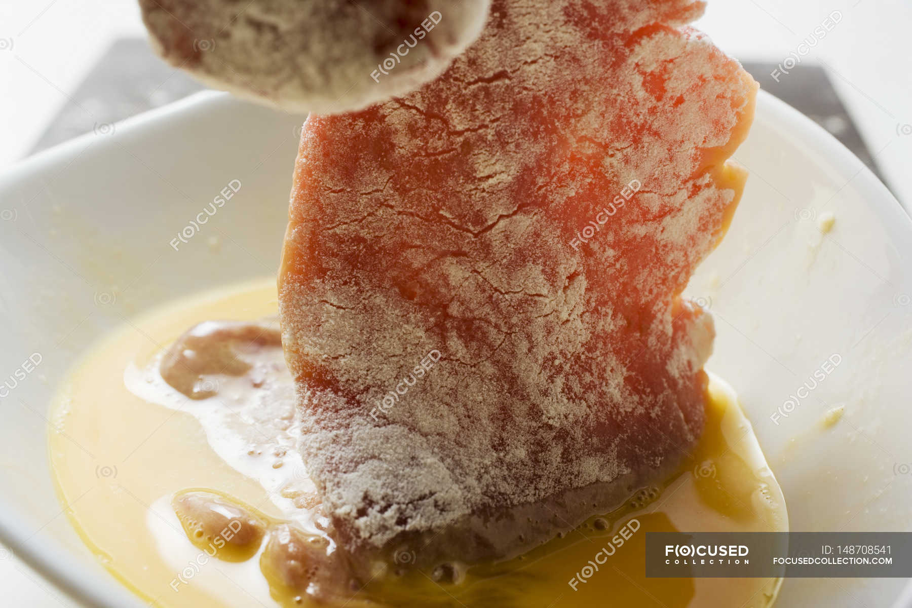 Dipping meat in egg — veal, plate Stock Photo 148708541