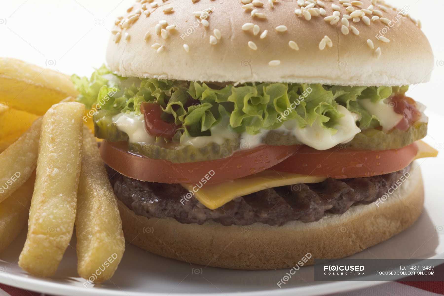 Cheeseburger with mayonnaise and chips — lifestyle, table setting ...