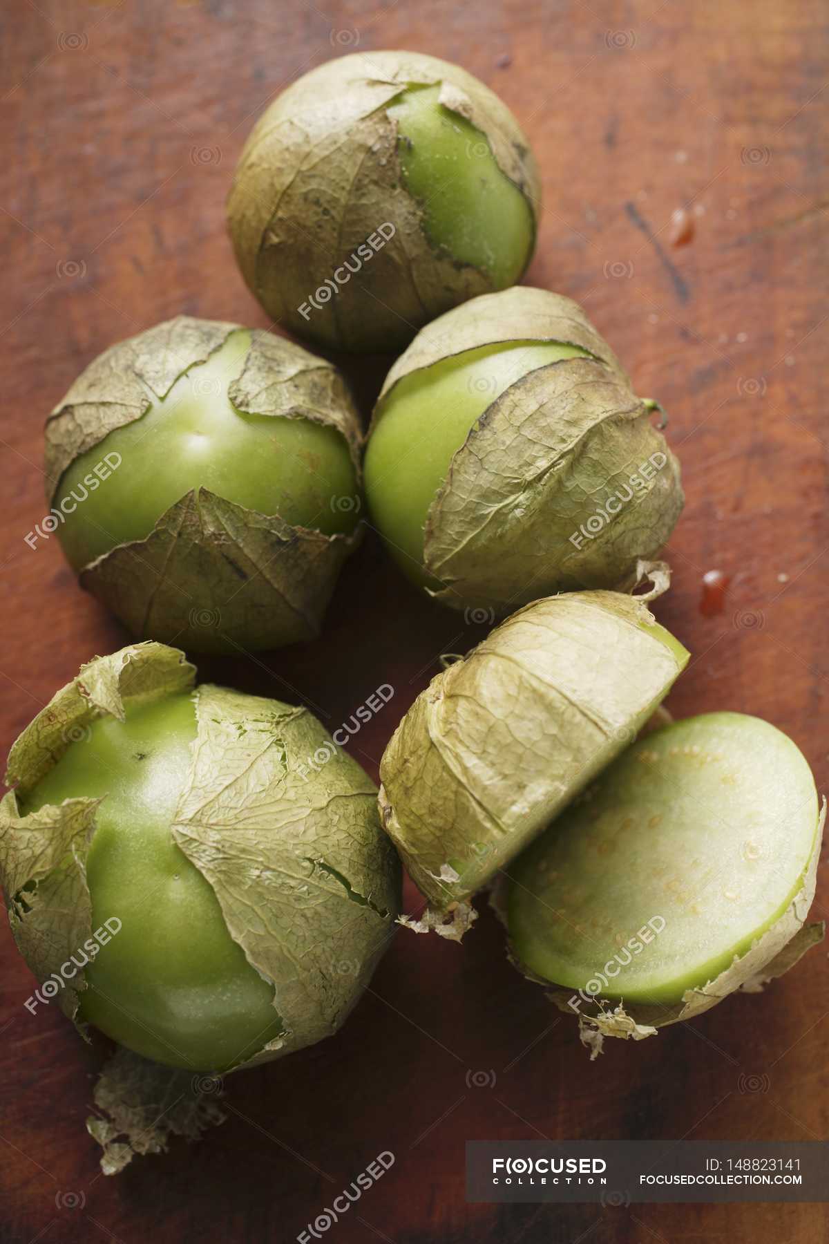 Several Tomatillos One Cut Open Over Wooden Surface Elements Lifestyle Stock Photo 148823141