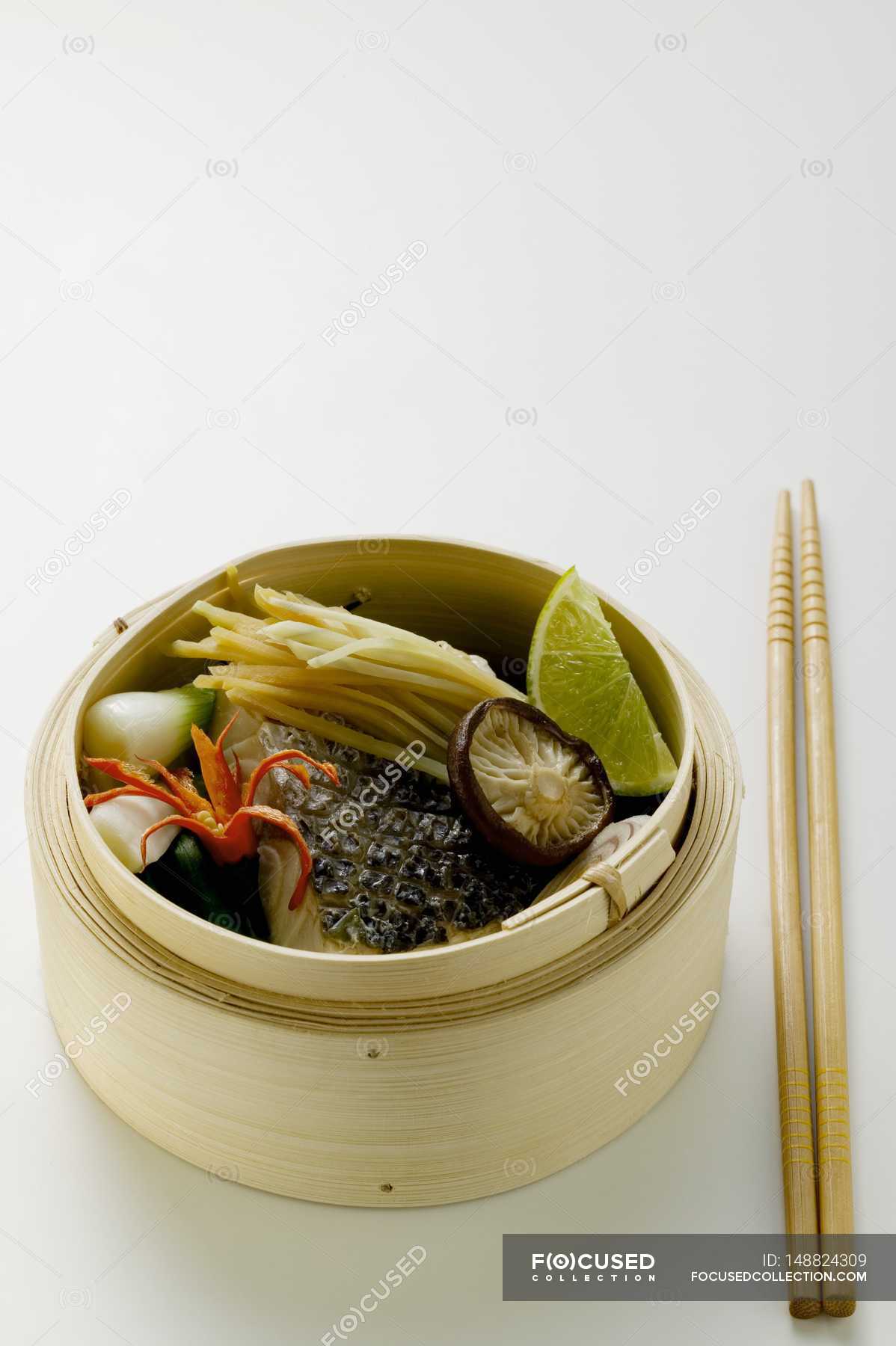Steamed sea bass with ginger and vegetables on white background — Ready ...