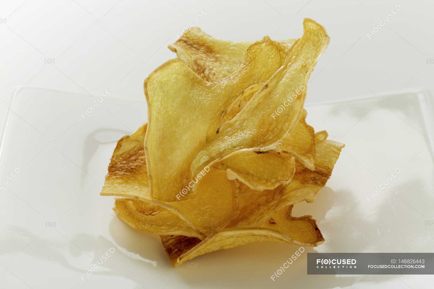 Deepfried ginger slices on plate — baking ingredient, taste Stock
