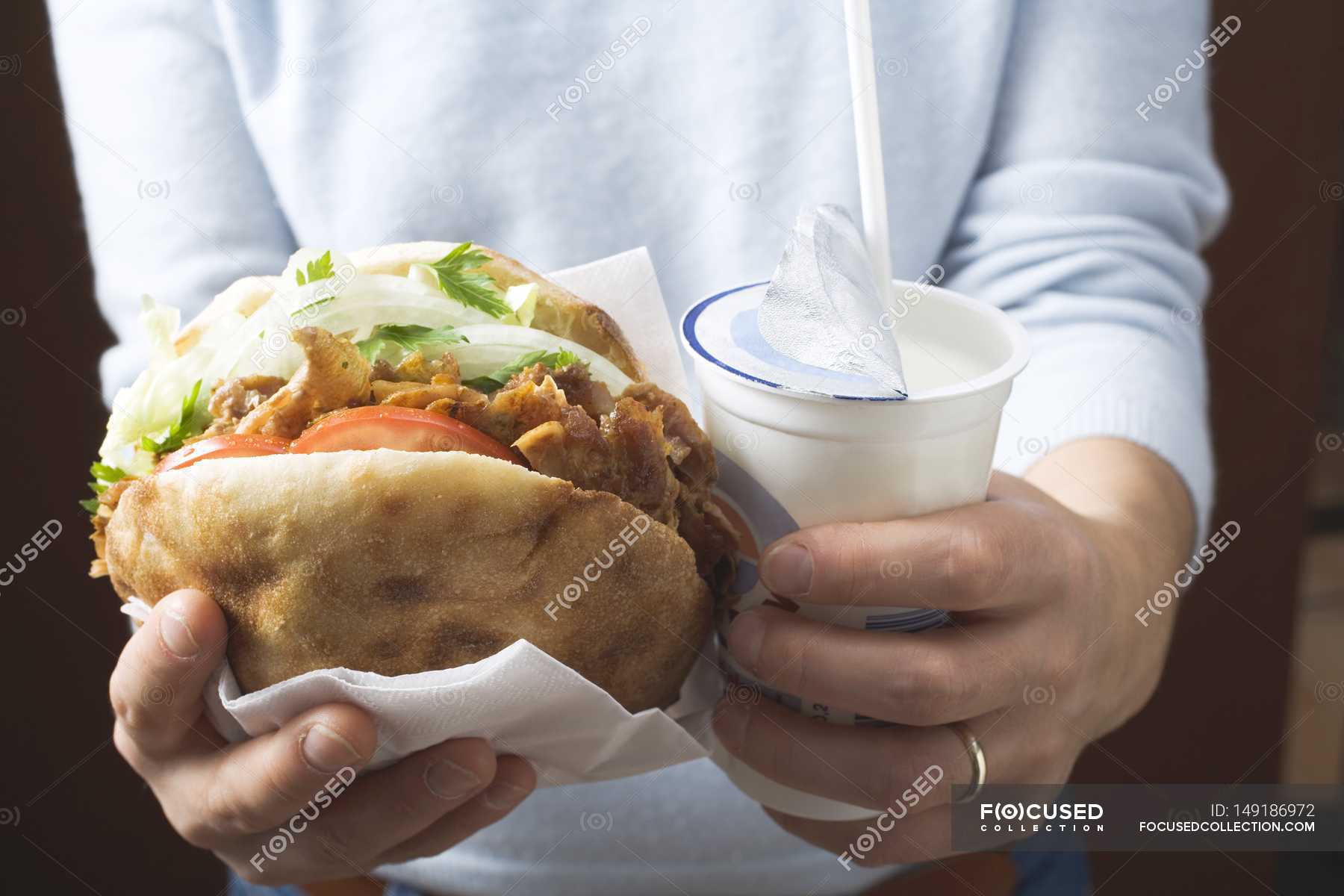 Hands holding doner kebab — dish, taste - Stock Photo | #149186972