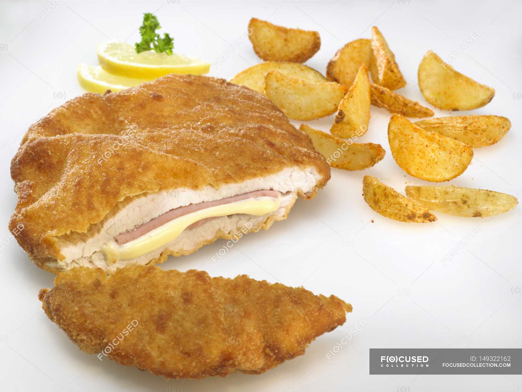 Chicken Cordon Bleu with potato wedges — root vegetables, cheese