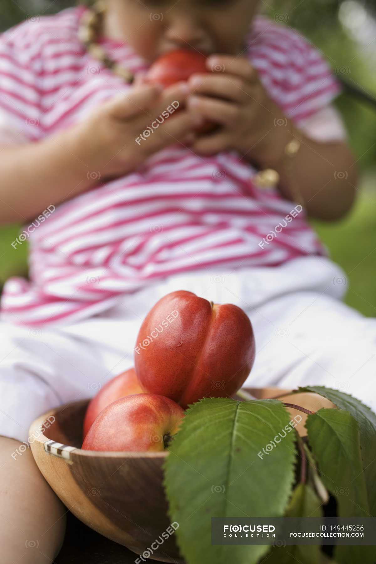 Child eating Nectarines — fruits, edible Stock Photo 149445256