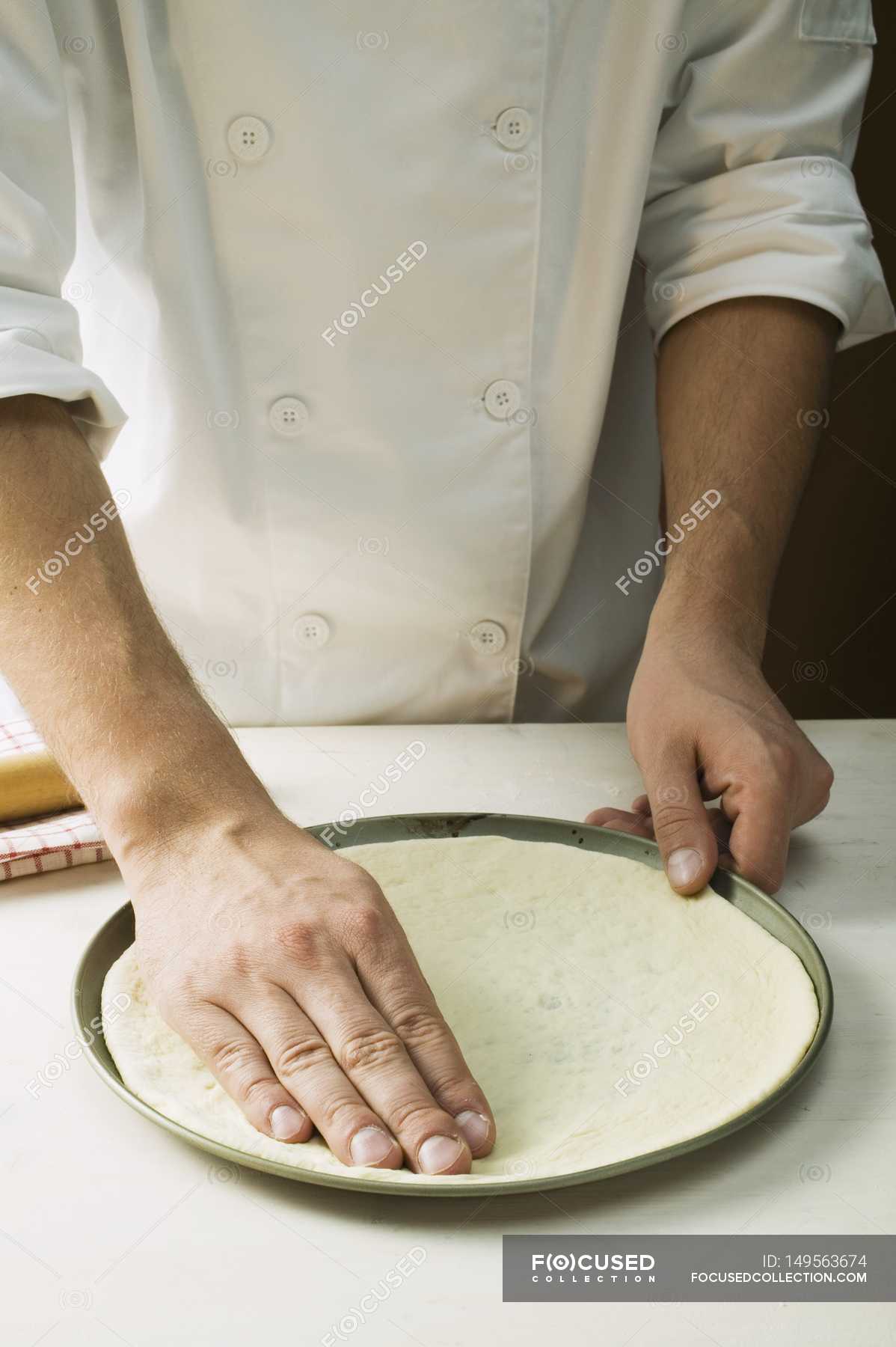 Chef pressing pizza dough — do it yourself, Front View Stock Photo 149563674