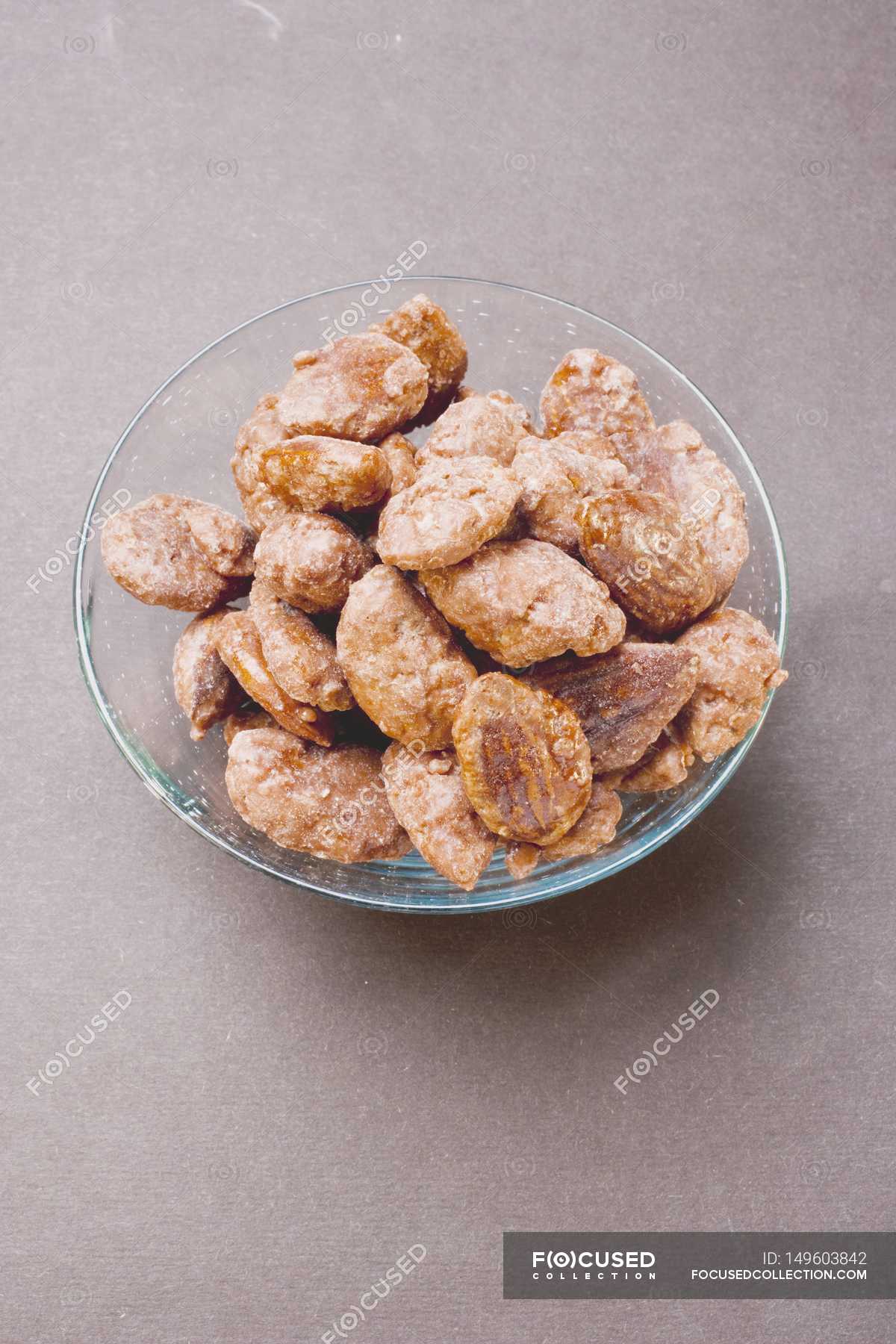Assorted nuts to nibble in glass bowl — delicious, grey Stock Photo