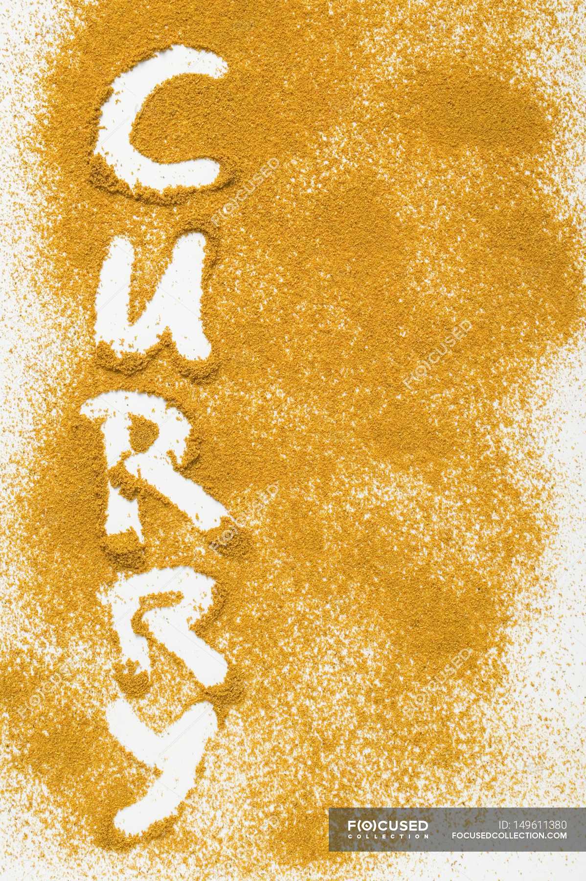 word-curry-written-in-curry-powder-background-top-view-stock-photo-149611380