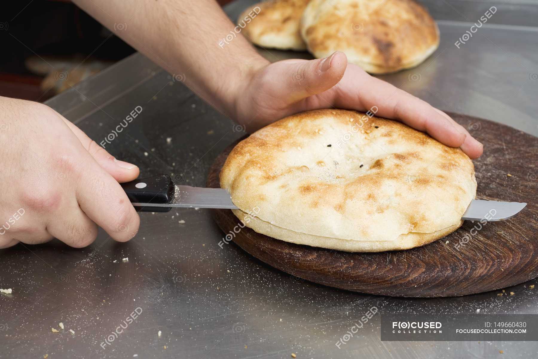 Hands splitting pita bread — food, cooked Stock Photo 149660430