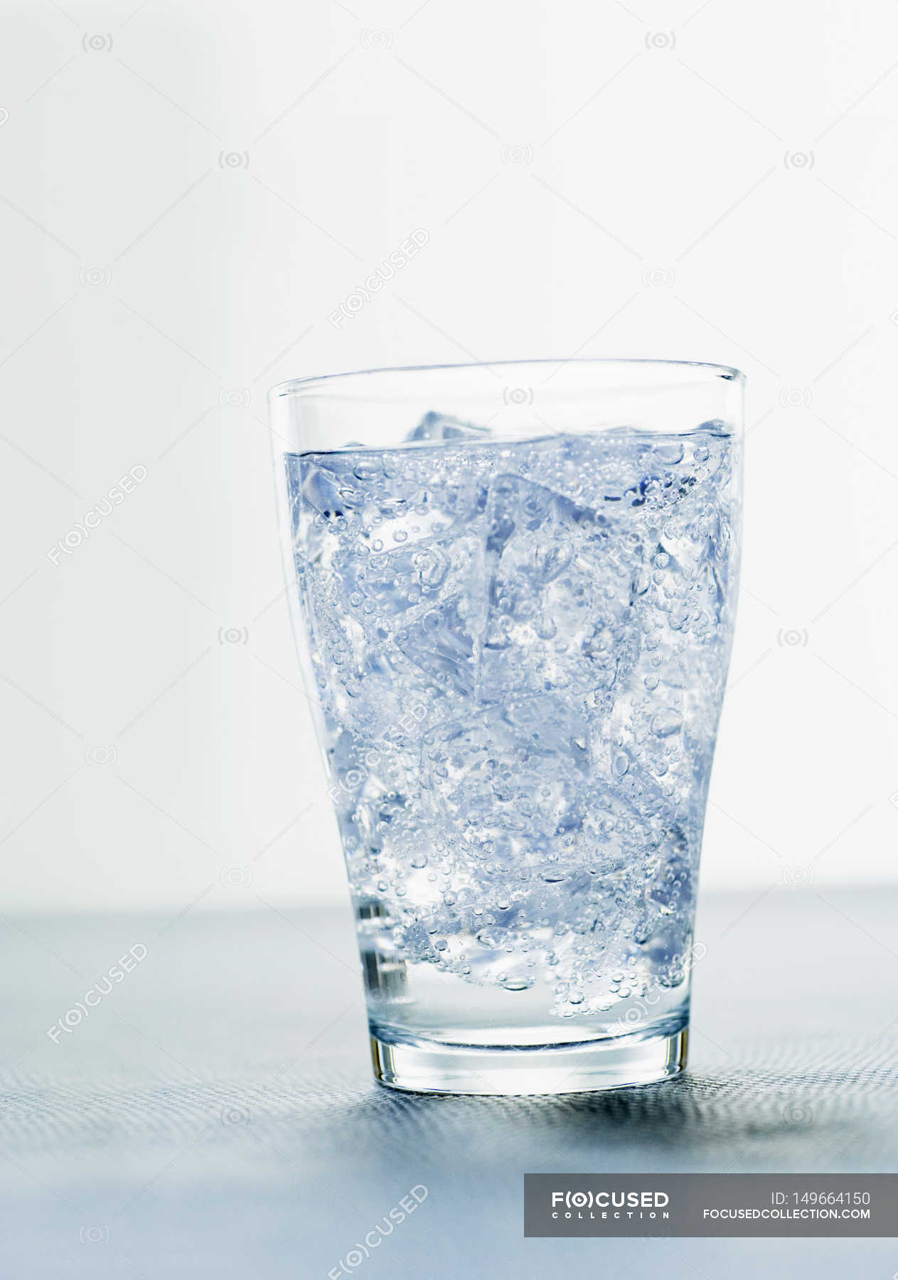 Glass of mineral water with ice cubes — uncooked, deep frozen - Stock ...