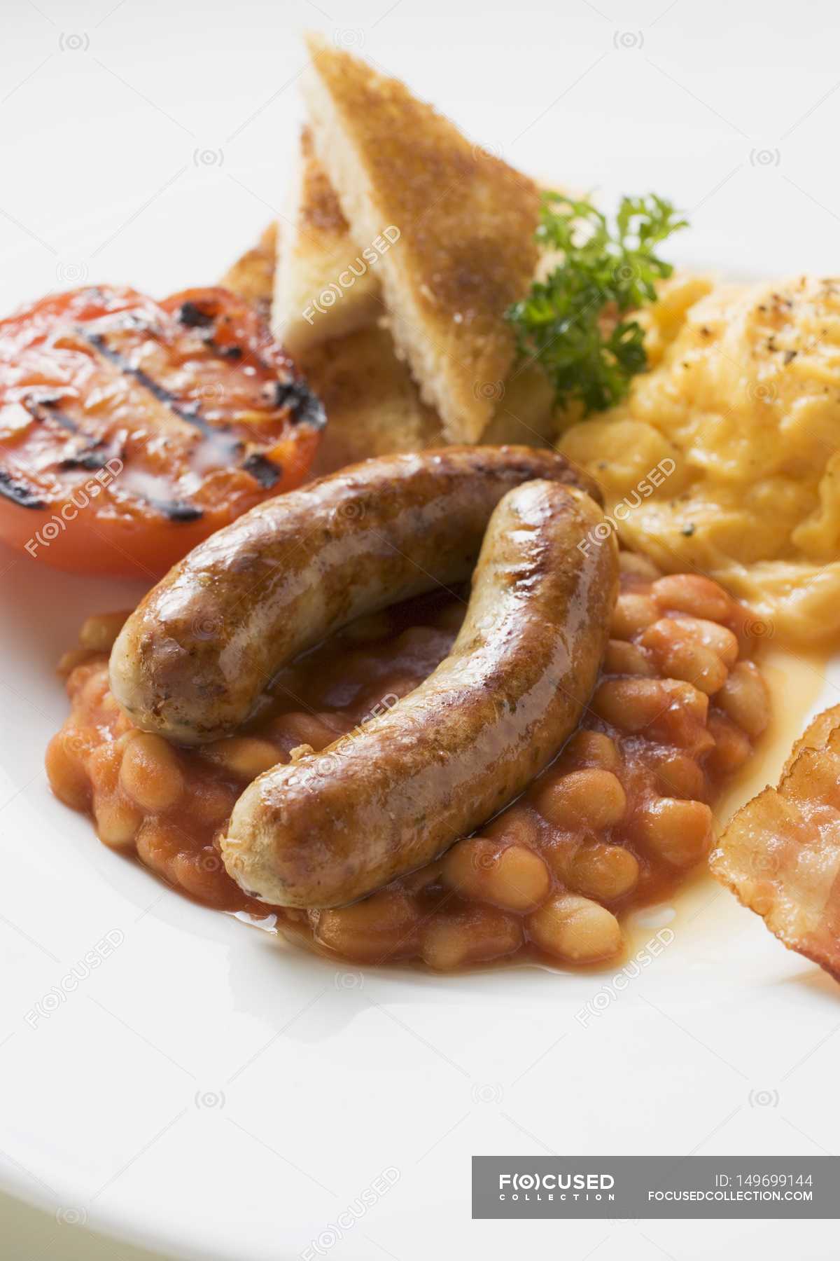 Baked beans, scrambled egg and sausages — vertical, Domestic Life Stock Photo 149699144