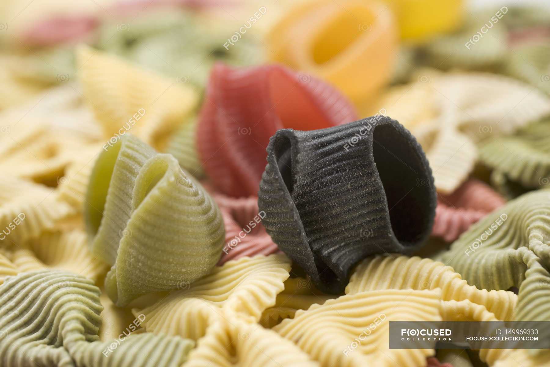 Various coloured pasta pieces — objects, cookery - Stock Photo | #149969330