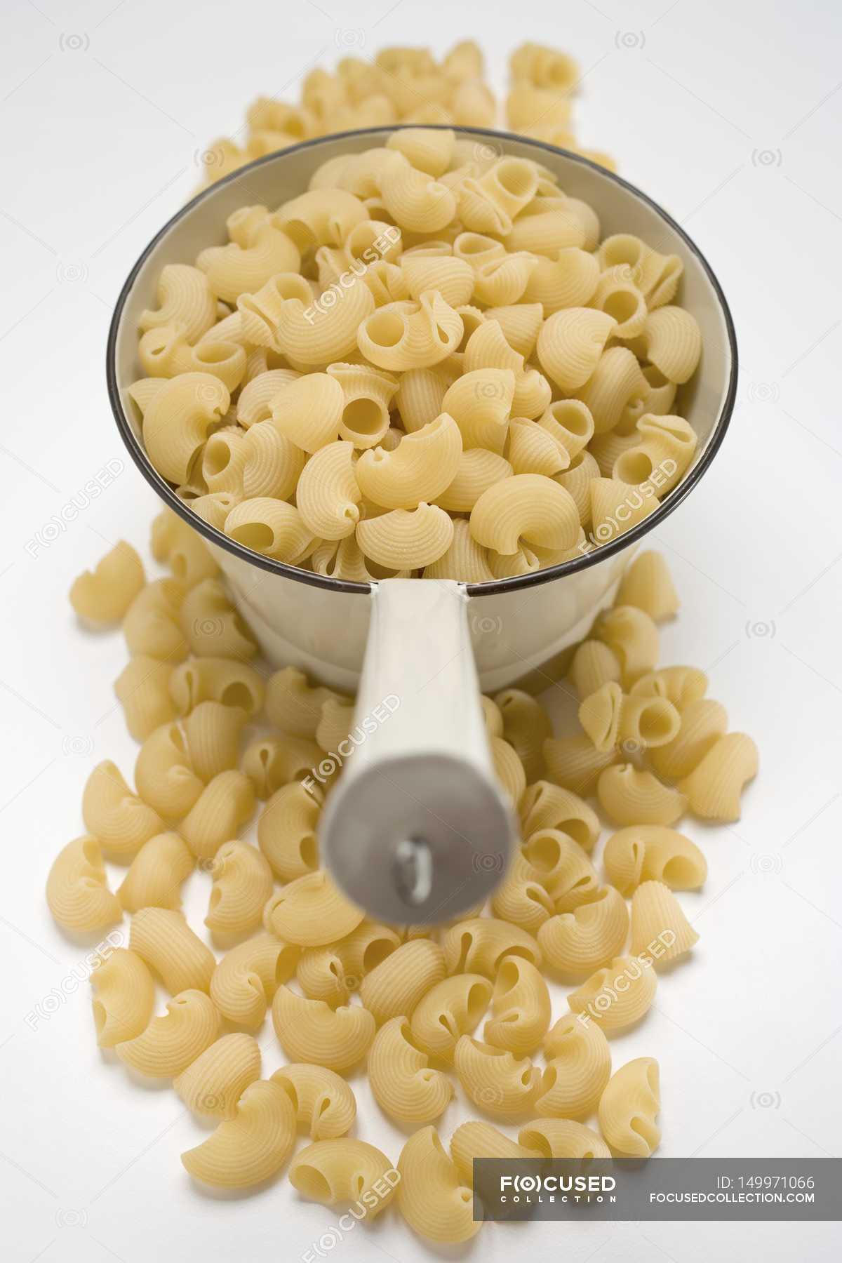 Dried Lumaconi pasta in strainer — lifestyle, wheat Stock Photo