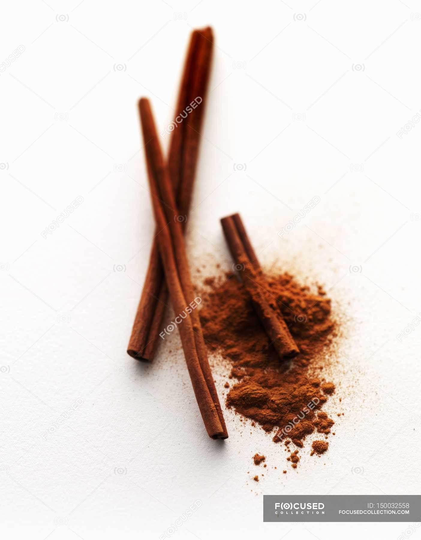 Cinnamon sticks and ground cinnamon — blurred, plan view Stock Photo