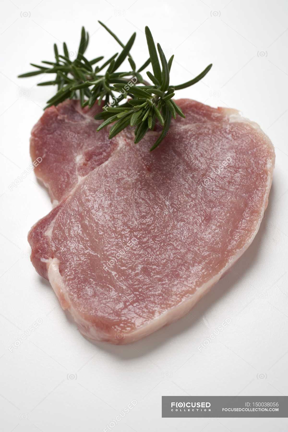 Raw pork chop with rosemary — cholesterol, sirloin Stock Photo