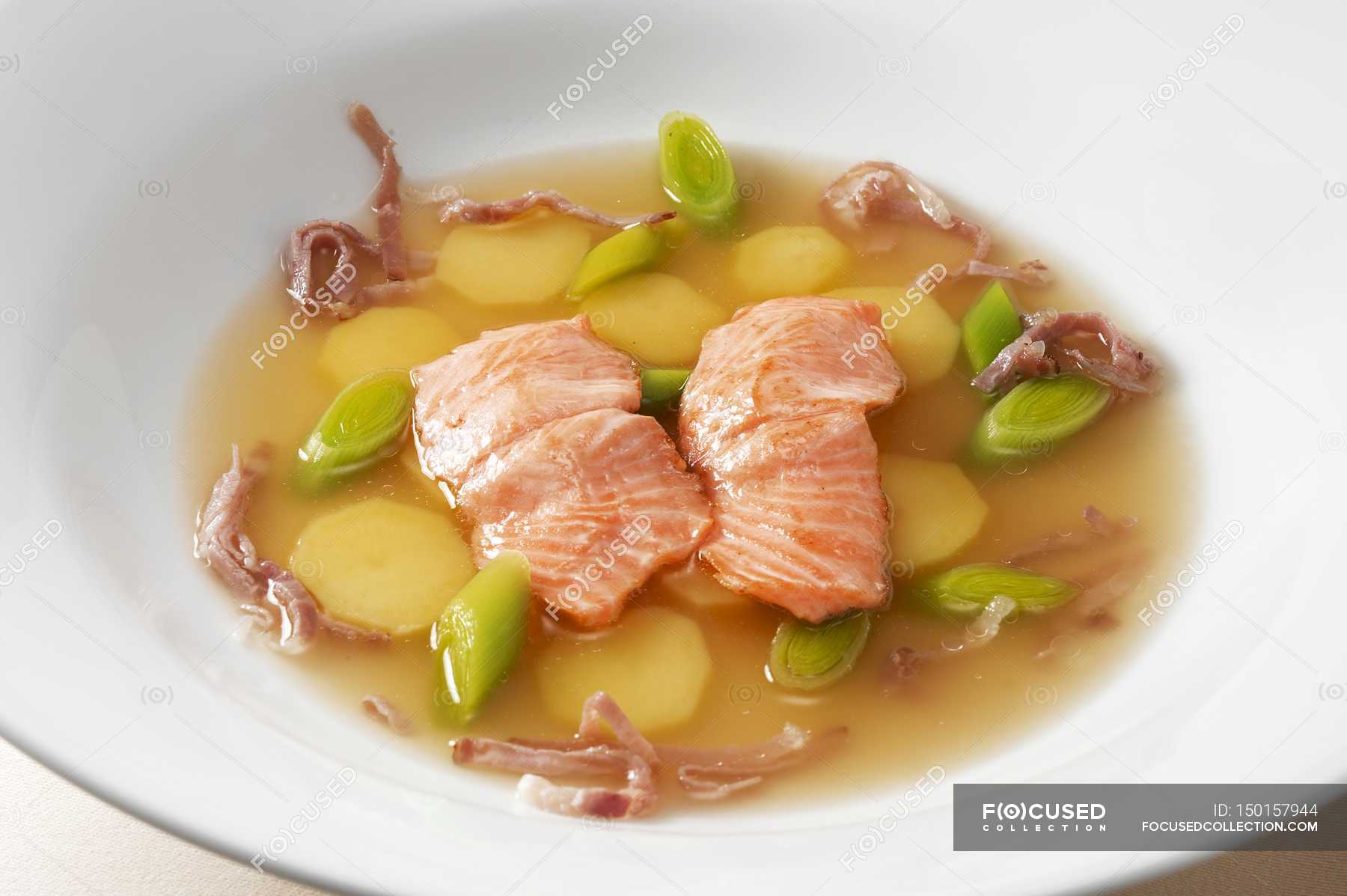 Closeup view of soup with trout fillet, potatoes and leek — nutritious