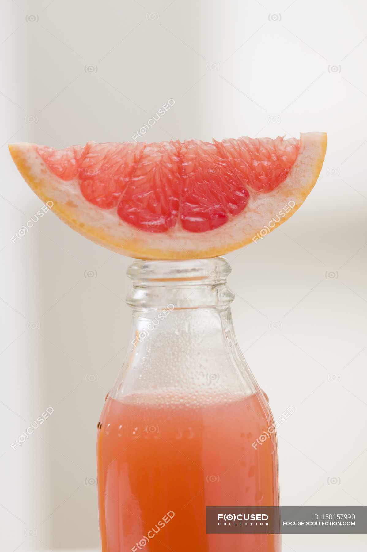 Pink grapefruit juice in bottle — liquid refreshments, pinkish Stock